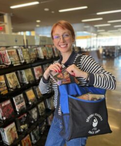 A library employee posing with a delivery bag.