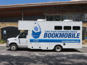 A large truck and attached cabin with text reading: "Lake Travis Community Library Bookmobile."